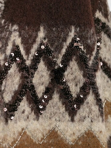 Detailed view of jacquard knit fabric with sparkling sequins and delicate beadwork