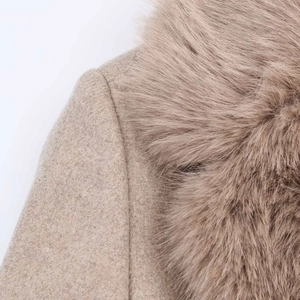 Close-up of a camel wool coat featuring a fluffy faux fur collar and premium texture
