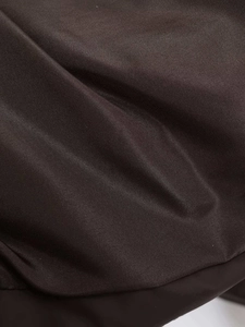 Detail of dark coffee brown high-density twill fabric and premium stitching texture