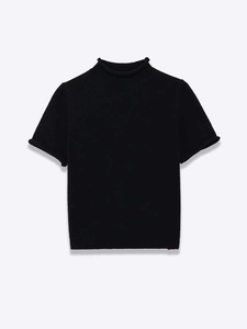 Detailed close-up of the rolled edge hem on a black mock neck short sleeve knit sweater