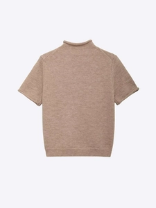 Detail view of brown knit sweater texture featuring high neck and rolled hem design