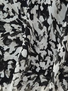 Macro shot of abstract ink print fabric with lightweight woven texture for women dress
