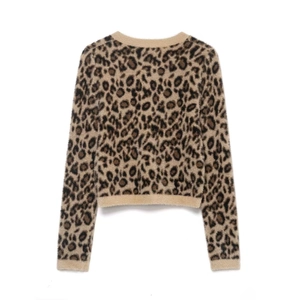 Back view of a cropped leopard print knit sweater with fuzzy texture and beige ribbed edges