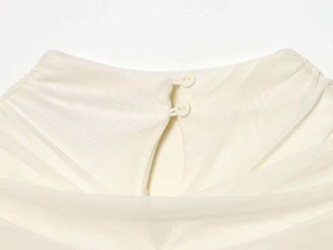 Close-up of high neck cream mesh dress showing delicate back button closure details