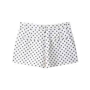 Detailed back view of high-waisted white shorts with black polka dots and welt pockets