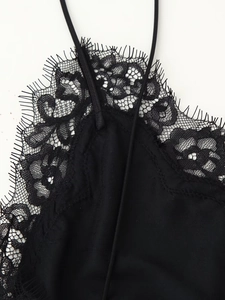 Détail d'une robe en velours noir avec dentelle de cils et fines bretelles élégantes