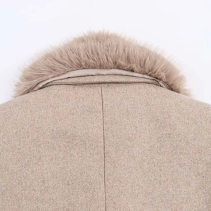 Detail of faux fur collar and wool blend fabric on a beige winter coat for women