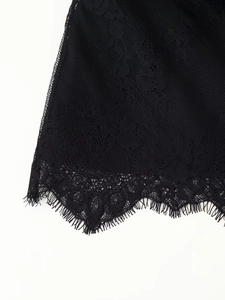 Detail of elegant black eyelash lace trim with fine floral patterns on a satin garment