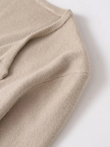 Detailed macro view showing the fine knit texture and neckline stitching of the oatmeal cardigan