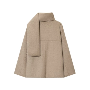Detail of oatmeal wool blend coat featuring elegant scarf collar and soft texture