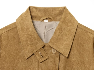 Detail of notch lapel and brown suede texture on a fashionable women's autumn coat