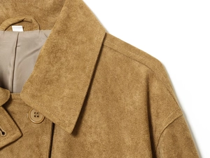 Detail of brown faux suede coat collar with smooth lining and neat stitching craftsmanship