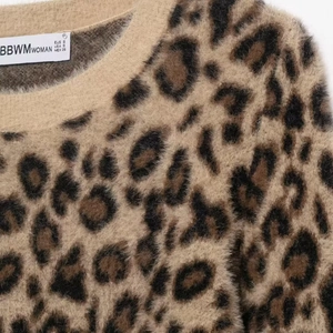 Women's leopard jacquard knit sweater with soft plush texture and crew neck design