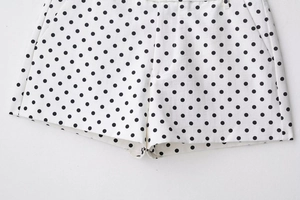Detail view of high waist polka dot shorts featuring side pockets and smooth fabric