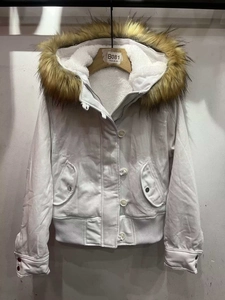 Detail of white winter jacket with fluffy brown faux fur collar and fleece lining