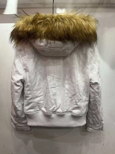 Detail of white cropped parka jacket with a detachable oversized brown faux fur collar