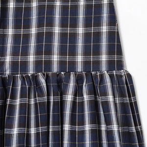 Vintage navy plaid midi skirt featuring elegant ruffled details and classic check pattern