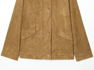 Detailed close-up of brown suede jacket showing front buttons and flap pockets