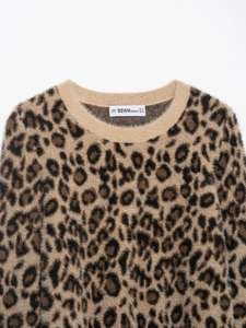 Close-up of leopard print faux fur knit sweater showing ribbed collar and fuzzy texture