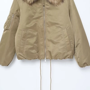 Detail view of khaki bomber jacket featuring faux fur collar and sleeve utility pocket