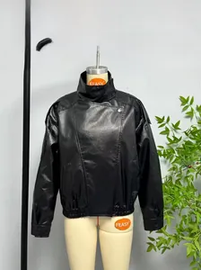 Detail of black faux leather jacket featuring stand collar and elastic pleated hem