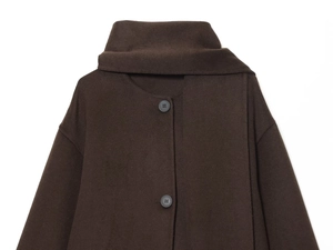 Detail of dark brown wool coat with matching scarf collar and black round buttons