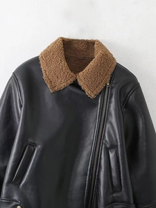 Detail of black faux leather biker jacket with brown faux shearling collar and zipper