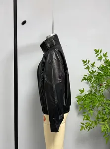 Macro detail of black faux leather motorcycle jacket with shoulder epaulets and stand collar