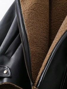 Detail of faux shearling lining and premium black leather texture on biker jacket