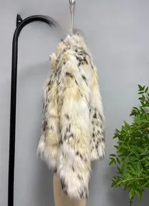 Close-up detail of luxurious faux fur coat texture with black and white spotted patterns