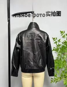 Detail of black faux leather jacket with ribbed cuffs and V-shaped back stitching