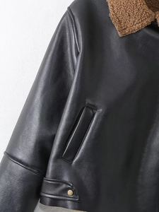 Detail of vintage faux leather jacket with brown fleece collar and gold metal snap buttons