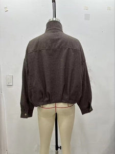 Back view of a dark brown herringbone bomber jacket with stand collar and retro texture