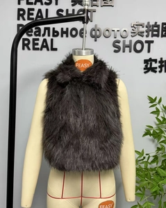 Detailed view of deep grey faux fur vest with fluffy texture and standing collar