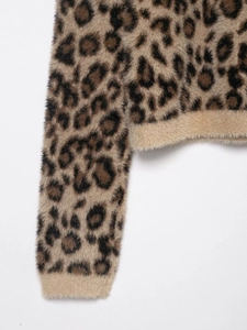 Detailed close-up of leopard print faux fur knit sweater with ribbed cuffs and fuzzy texture