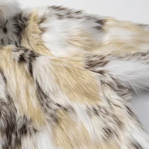 Macro texture of soft faux fur jacket with mixed white and brown spotted pattern
