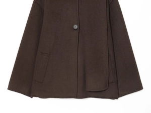 Close-up of chocolate brown wool jacket featuring matte black button and pocket details
