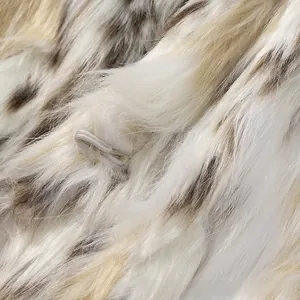 Macro shot of faux fur texture with drawcord loop closure on spotted plush coat