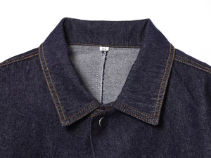Detail of classic collar and silver button on dark blue denim cape jacket with orange stitching