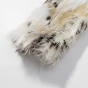 Macro shot of faux fur texture with black spots on a cream base for luxury women jacket