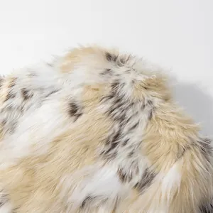 Close-up of soft faux fur texture with beige and brown spotted pattern for winter coat