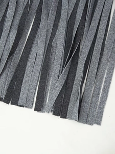Detailed close-up showing grey felt fringe and black mesh texture on long coat hem