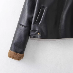 Vintage black faux leather biker jacket with brown fleece lining and cuff details