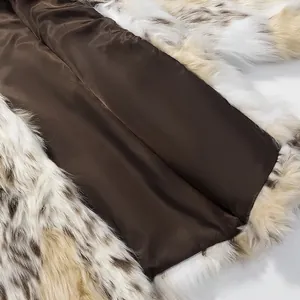 Close-up of luxury faux fur coat with spotted texture and brown satin lining
