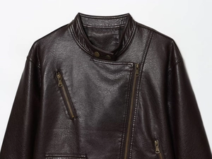 Detail view of burgundy PU leather biker jacket featuring metallic zippers and snap-button collar