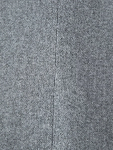 Detailed macro shot of dark grey wool fabric showing fine stitching and thick texture