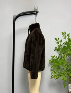 Close-up of a deep brown high-collar fleece jacket with thick faux shearling texture