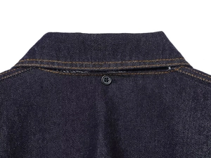 Close-up of dark blue denim cape top with contrast orange stitching and button detail