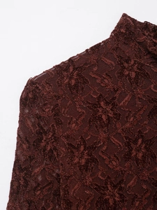 Detailed macro view of the high neck and shoulder with floral flocking on burgundy lace