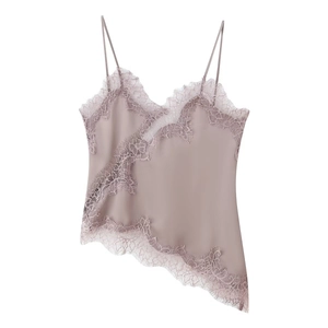 Close-up of a pink satin camisole featuring delicate eyelash lace trim and asymmetric hem